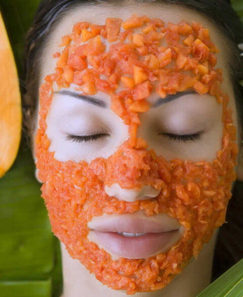 Beautiful woman having Fresh Papaya Facial Mask apply. Fresh Papaya