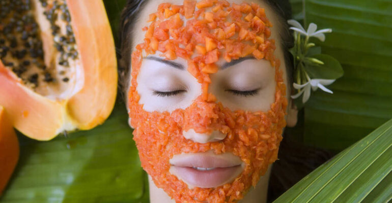 Beautiful woman having Fresh Papaya Facial Mask apply. Fresh Papaya