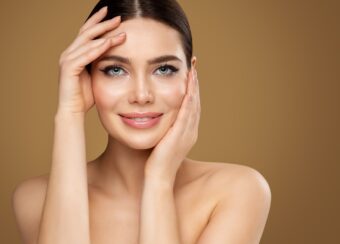 Face Skin Care. Beauty Model doing Facial Lifting Massage. Smili