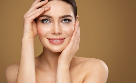 Face Skin Care. Beauty Model doing Facial Lifting Massage. Smili